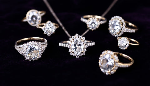 A jewelry auction lot of rings and a necklace displayed for evaluation