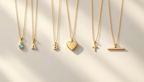 Assortment of gold pendant necklace styles laid flat