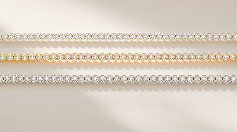 Three tennis bracelets in diamond, CZ gold-plated, and silver styles arranged in a flat lay