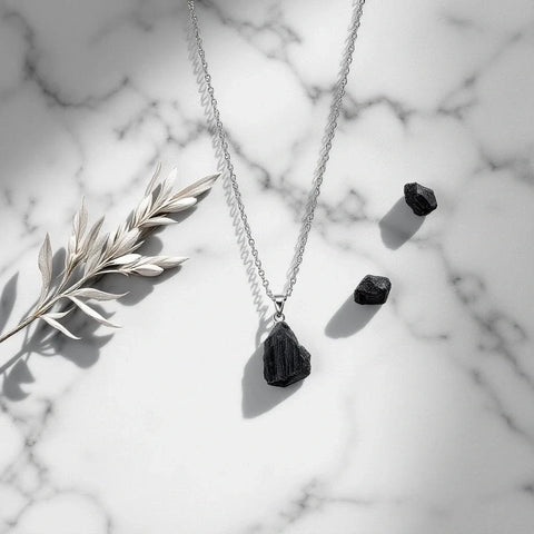 Black tourmaline pendant necklace on marble — black tourmaline meaning and protection properties