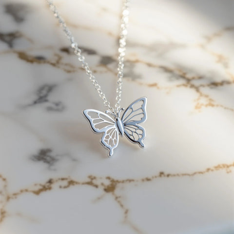 Butterfly necklace meaning — delicate silver butterfly pendant symbolising transformation and freedom