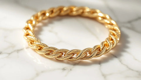 Gold snake-chain anklet coiled on white marble, Bvlgari Serpenti-inspired dupe jewelry