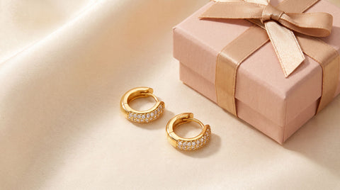 Gold diamond-cut huggie hoop earrings styled as a citizenship gift