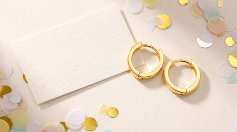 Gold hoop earrings styled as a congratulations gift