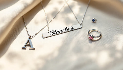 Personalized sterling silver custom jewelry pieces including a nameplate necklace, initial ring, and birthstone pendant