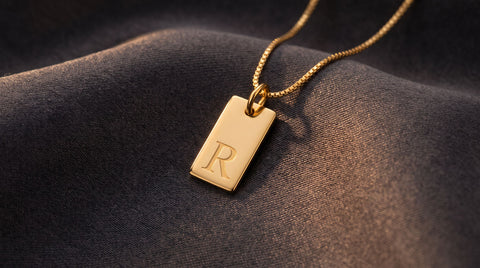 Rectangular gold tag pendant necklace styled as a dog tag necklace