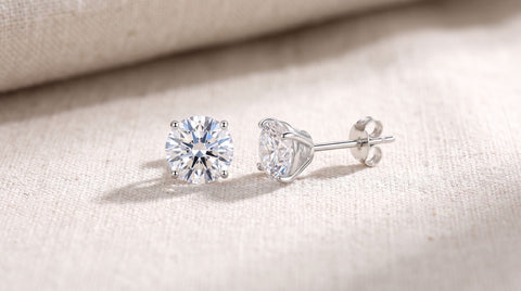 Sterling silver cubic zirconia stud earrings on a neutral surface