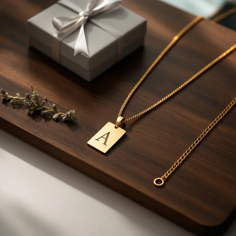 Father's Day jewelry gift ideas — personalized initial necklace and chain on dark wood