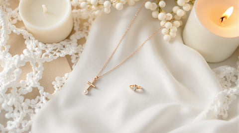 Dainty pearl necklace and small cross ring styled as a first communion jewelry gift on white lace fabric