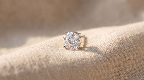 Hypoallergenic sterling silver stud earring on a neutral fabric surface