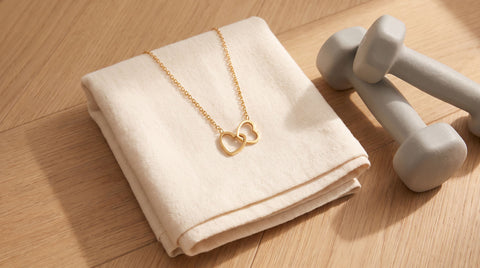 Gold double heart necklace styled as a personal trainer gift