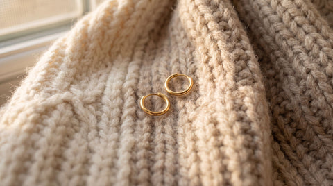 Thin gold huggie earrings styled as a gift for a homebody
