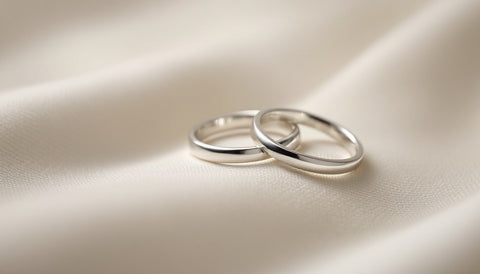A matching pair of rings for a couple displayed together on a neutral surface