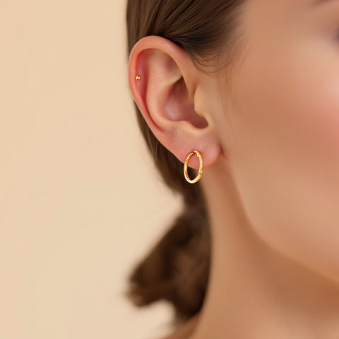 Huggie earrings for cartilage — graduated stack with 10mm, 8mm, and 6mm huggies at lobe and helix
