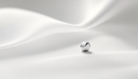 Small plain titanium nose stud on a soft neutral surface