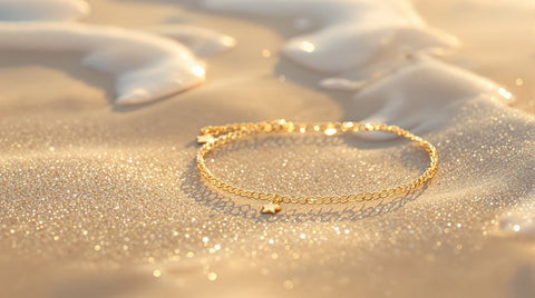 Dainty gold-plated waterproof anklets on beach sand