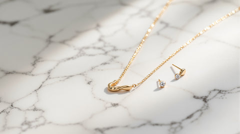 Minimalist solid gold and gold vermeil jewelry on marble, fine jewelry photography