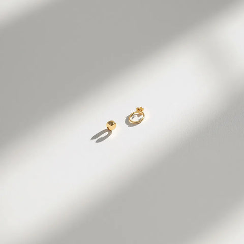Gold vermeil stud earrings and ring on white background