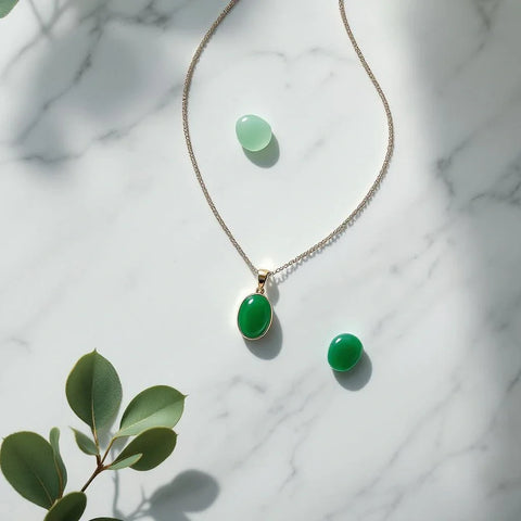 Jade pendant necklace with emerald green jade stone on marble — jade meaning and symbolism guide