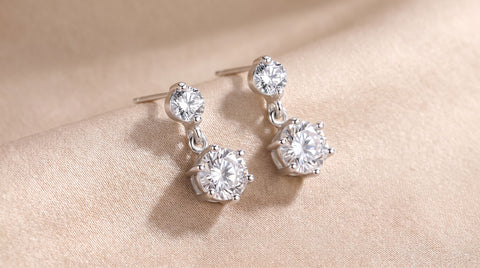 925 sterling silver CZ dangle earrings on a neutral surface