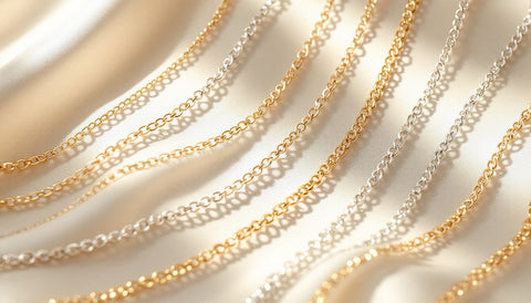 Sterling silver and gold-plated necklace chains of different lengths laid out together