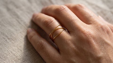 Hand wearing a triple wire-wrap non-traditional wedding ring
