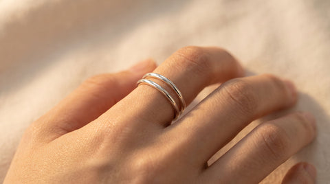 Sterling silver open band ring with an adjustable open shank, close-up product photo