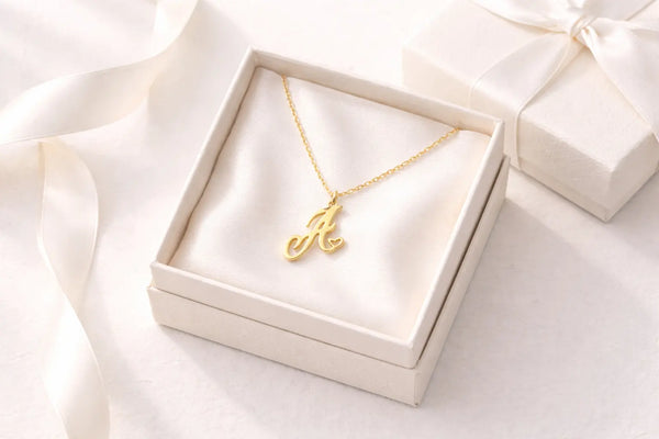 Personalized gold heart initial necklace for mom on white marble surface, 18K gold plated
