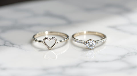 Promise ring and engagement ring side by side comparison on marble