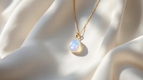 Rainbow moonstone pendant necklace flat lay showing blue violet flash
