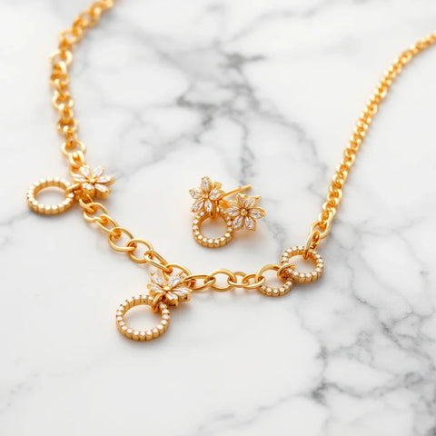 18K gold plated necklace and earrings displayed on white marble, editorial jewelry photography