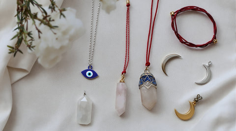 Spiritual jewelry collection with evil eye, crystal and celestial necklaces on linen — spiritual jewelry meaning guide