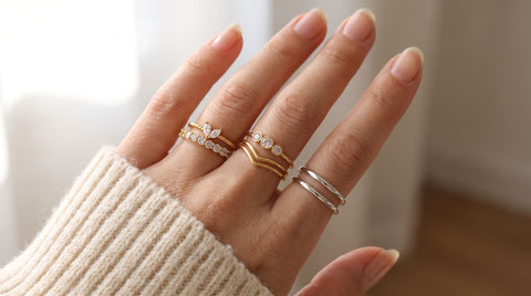 AJLuxe stacking ring sets in gold and silver stacked together on a hand