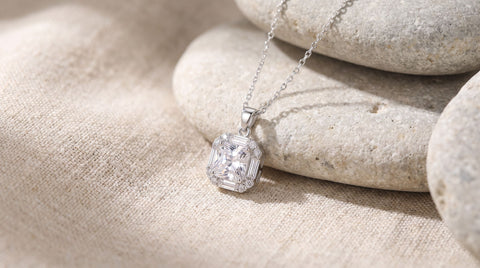 Round brilliant cut CZ pendant styled with natural linen and stone surface