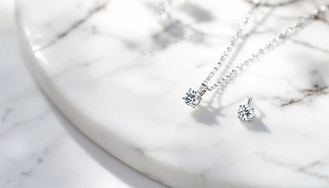 Sparkling cubic zirconia stud earrings and pendant necklace on white marble, Swarovski crystal dupe jewelry in sterling silver