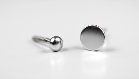 Close-up comparison of a threaded earring post and a threadless push-pin earring post side by side