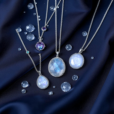 Water signs astrology — Cancer, Scorpio and Pisces birthstone jewelry on navy silk