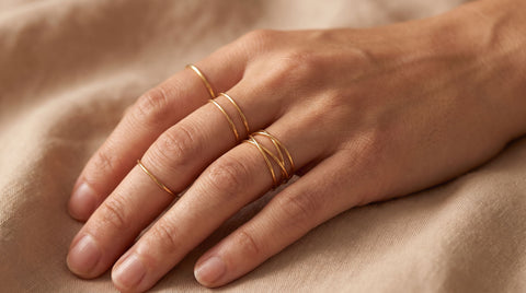 18K gold-plated triple wire wrap ring stacked with thin gold bands on a hand, worn as an everyday ring