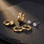 Load image into Gallery viewer, Earring Stack Set detail — all 3 pairs, 6 pieces, on dark stone: gold dome hoops, gold huggies and CZ studs
