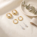 Load image into Gallery viewer, Earring Stack Set flat lay — 3 matched pairs of 18K gold plated 925 sterling silver earrings on linen
