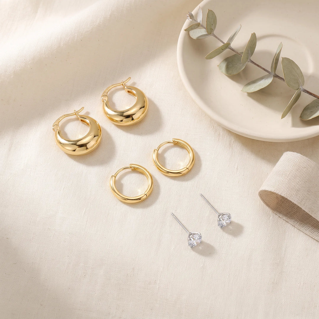 Earring Stack Set flat lay — 3 matched pairs of 18K gold plated 925 sterling silver earrings on linen