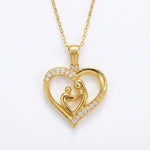 Load image into Gallery viewer, Mom Heart Necklace in 18K gold plated stainless steel, mother and child heart pendant with CZ pave stones, white background
