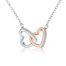 Interlocking Hearts Necklace, real product photo, two-tone pendant with an imitation rhodium CZ pave heart interlocked with a rose gold plated heart, on a curb chain, white background