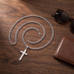 Load image into Gallery viewer, Men's stainless steel cross necklace flat lay with sunglasses and leather wallet
