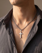Load image into Gallery viewer, Man wearing the men's cross necklace on a Cuban link chain with an open-collar shirt
