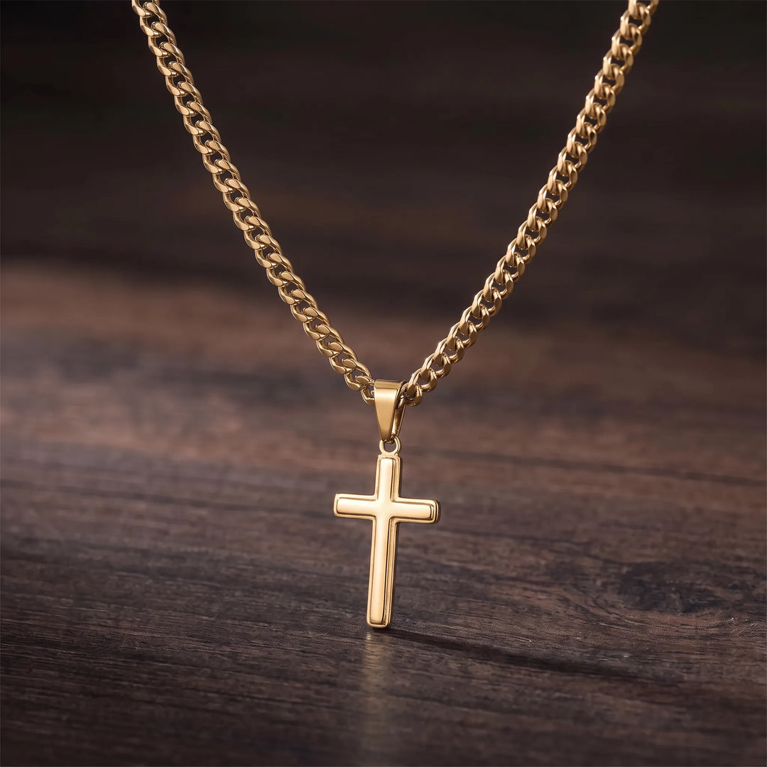 Gold-tone cross pendant and Cuban link chain, close detail