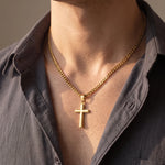Load image into Gallery viewer, Man wearing the gold cross necklace on a gold-tone Cuban link chain with an open-collar shirt
