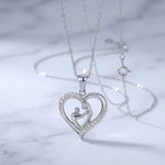 Lade Bild in die Galerieansicht, Mom Heart Necklace in silver-tone stainless steel styled on a marble surface
