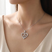Mom Heart Necklace in silver-tone stainless steel worn on neck, mother and child heart pendant