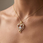 Load image into Gallery viewer, Love Knot Heart Necklace worn at the collarbone, 18K gold-tone finish
